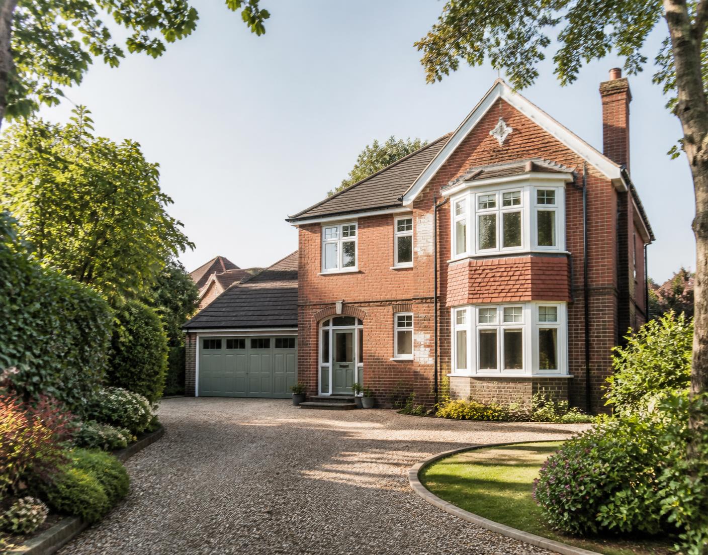 Detached British family home with off-road parking, typical of a C2 conversion candidate